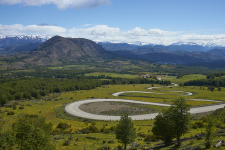 The Carretera Austral; famous road connecting remote towns and villages in northern Patagonia, Chile. Curved section running through farmland near the small town of Cerro Castillo.の写真素材