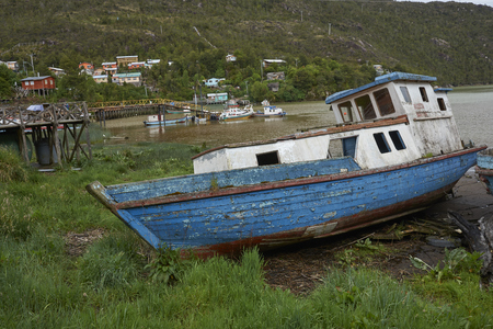 Tortel, Patagonia, Chile - November 16, 2017: Wooden fishing boat beached on the coast in the small village of Tortel in northern Patagonia, Chile.のeditorial素材