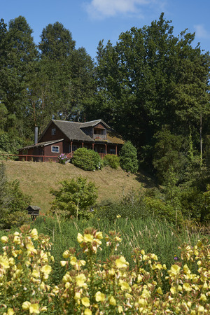 Frutillar, Los Largos, Chile - January 24, 2018:  Traditional wooden farm buildings set in the landscaped gardens of the German Colonial Museum in Frutillar in the Lake District of southern Chile.のeditorial素材