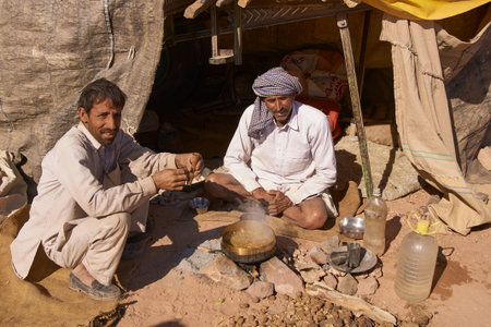 Nagaur, Rajasthan, India - February 13, 2008: Men preparing a meal outside their makeshift tent...