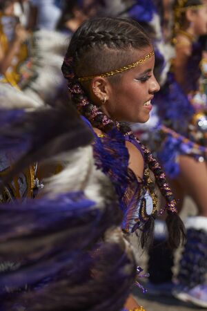 Arica, Chile - February 10, 2017: Female member of a Tobas dance group in ornate costume performing at the annual Carnaval Andino con la Fuerza del Sol in Arica, Chile.のeditorial素材