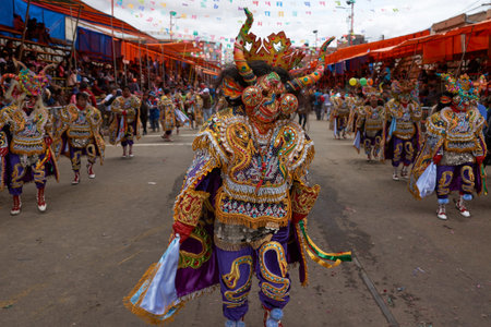 ORURO, BOLIVIA - FEBRUARY 26, 2017: Diablada dancers in ornate costumes parade through the mining...