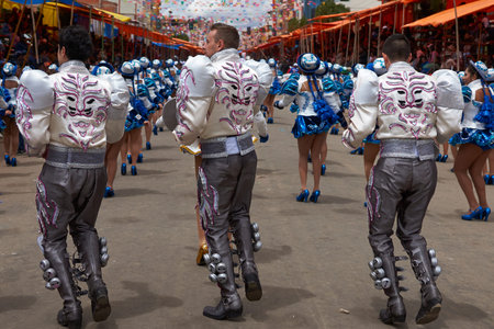 ORURO, BOLIVIA - FEBRUARY 26, 2017: Caporales dancers in ornate costumes performing as they parade...