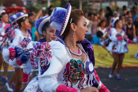 ARICA, CHILE - FEBRUARY 10, 2017: Female members of a Caporales dance group in ornate costumes...