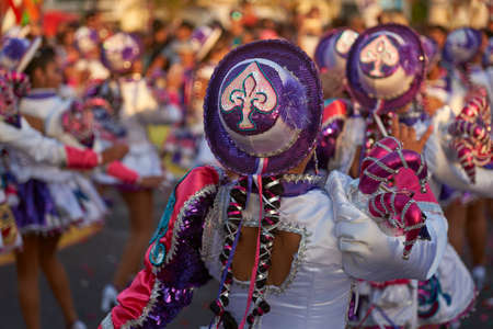 ARICA, CHILE - FEBRUARY 10, 2017: Female members of a Caporales dance group in ornate costumes performing at the annual Carnaval Andino con la Fuerza del Sol in Arica, Chile.のeditorial素材