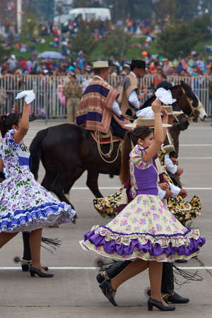 SANTIAGO, CHILE - SEPTEMBER 19, 2015: Traditional cueca dance group performing at the annual Military parade as part of the Fiestas Patrias commemorations in Santiago, Chile..のeditorial素材