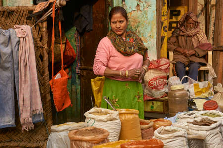 DELHI, INDIA - FEBRUARY 5, 2009: Lady selling spices in a street market in Old Delhi, Indiaのeditorial素材