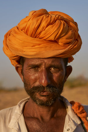 Pushkar, Rajasthan, India - November 6, 2008: Portrait of a camel herder at the annual Pushkar Fair...