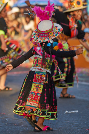 Arica, Chile - January 23, 2016: Tinkus dancing group in colourful costumes performing a traditional ritual dance as part of the Carnaval Andino con la Fuerza del Sol in Arica, Chile.のeditorial素材