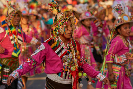 Arica, Chile - January 23, 2016: Tinkus dancing group in colourful costumes performing a traditional ritual dance as part of the Carnaval Andino con la Fuerza del Sol in Arica, Chile.のeditorial素材