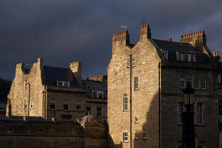 Bath, England, United Kingdom - October 5, 2021: Sunlit buildings surrounding Pulteney Bridge over the River Avon in the historic city of Bath in the United Kingdomのeditorial素材