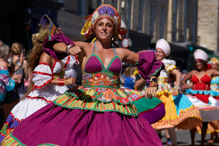 Bath, England, United Kingdom - 9 July 2022: Dancers in ornate costumes performing at the annual carnival as it progresses through the streets of the historic city of Bath in Somerのeditorial素材