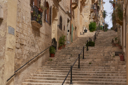 Valetta, Malta - June 8, 2023: Historic buildings lining narrow streets in the city of Valetta in Maltaのeditorial素材