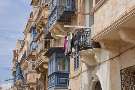 Valetta, Malta - June 8, 2023: Historic buildings lining narrow streets in the city of Valetta in Maltaのeditorial素材
