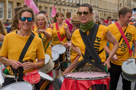 Bath, England, United Kingdom - 8 July 2023: Dancers and musicians dressed in ornate costumes parade...