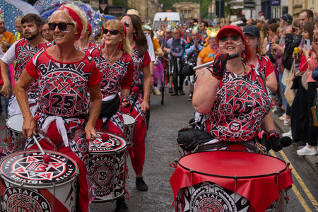 Bath, England, United Kingdom - 8 July 2023: Dancers and musicians dressed in ornate costumes parade through the streets of Bath in the annual carnival.のeditorial素材
