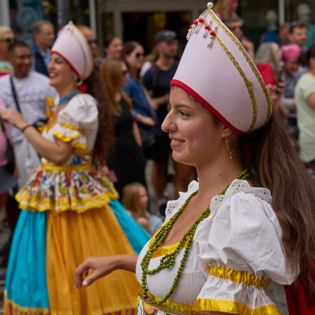Bath, England, United Kingdom - 8 July 2023: Dancers and musicians dressed in ornate costumes parade through the streets of Bath in the annual carnival.のeditorial素材