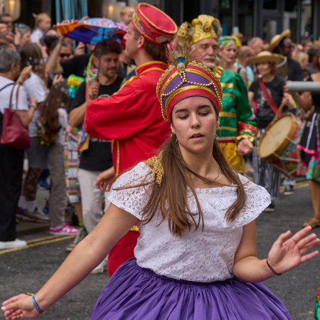 Bath, England, United Kingdom - 8 July 2023: Dancers and musicians dressed in ornate costumes parade through the streets of Bath in the annual carnival.のeditorial素材