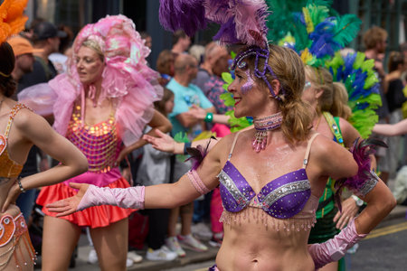 Bath, England, United Kingdom - 8 July 2023: Dancers and musicians dressed in ornate costumes parade through the streets of Bath in the annual carnival.のeditorial素材