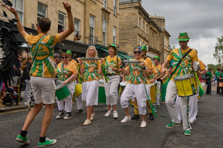 Bath, England, United Kingdom - 8 July 2023: Dancers and musicians dressed in ornate costumes parade...