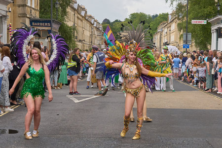 Bath, England, United Kingdom - 8 July 2023: Dancers and musicians dressed in ornate costumes parade...