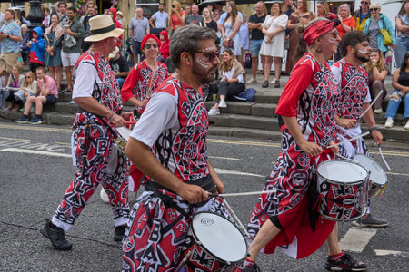 Bath, England, United Kingdom - 8 July 2023: Dancers and musicians dressed in ornate costumes parade through the streets of Bath in the annual carnival.のeditorial素材