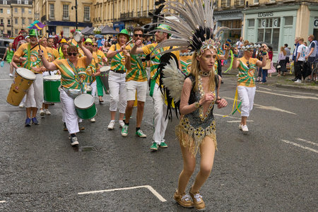 Bath, England, United Kingdom - 8 July 2023: Dancers and musicians dressed in ornate costumes parade...