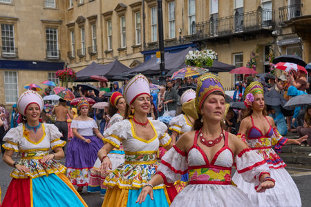 Bath, England, United Kingdom - 8 July 2023: Dancers and musicians dressed in ornate costumes parade through the streets of Bath in the annual carnival.のeditorial素材