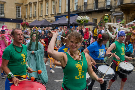Bath, England, United Kingdom - 8 July 2023: Dancers and musicians dressed in ornate costumes parade through the streets of Bath in the annual carnival.のeditorial素材