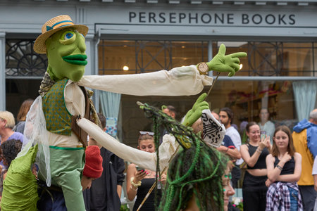 Bath, England, United Kingdom - 8 July 2023: Dancers and musicians dressed in ornate costumes parade through the streets of Bath in the annual carnival.のeditorial素材