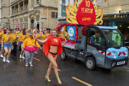 Bath, England, United Kingdom - 8 July 2023: Dancers and musicians dressed in ornate costumes parade through the streets of Bath in the annual carnival.のeditorial素材