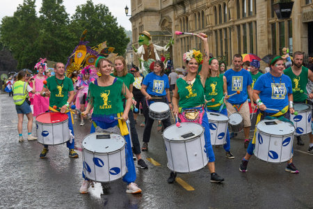 Bath, England, United Kingdom - 8 July 2023: Dancers and musicians dressed in ornate costumes parade...
