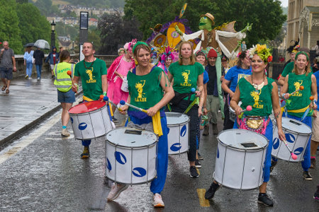 Bath, England, United Kingdom - 8 July 2023: Dancers and musicians dressed in ornate costumes parade through the streets of Bath in the annual carnival.のeditorial素材