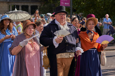 Bath, England, United Kingdom - 9 September 2023: Parade of people dressed in period costume from the Georgian era as part of the annual Jane Austen festival in Bath, Somerset, UKのeditorial素材