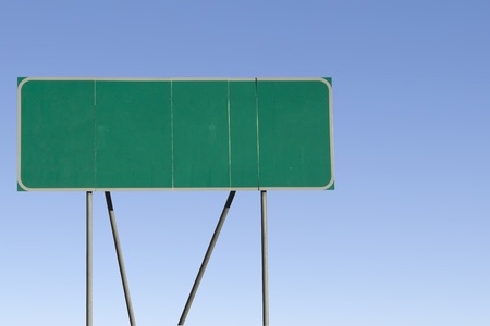 Green road sign with a blue sky gradient background.の写真素材