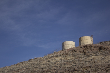two water tanks on a mountain sideの写真素材