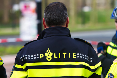 Policeman with barrier tape