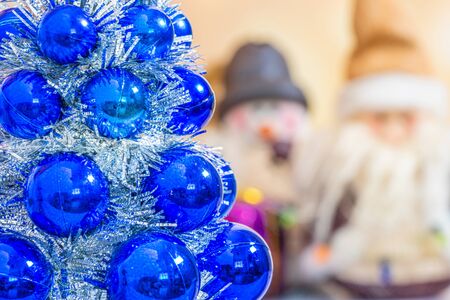 Christmas collection, gifts and decorative ornaments. Holiday Season background with decorations. Blue, green xmas trees. Gift boxes various colours. Copy space for text.の写真素材