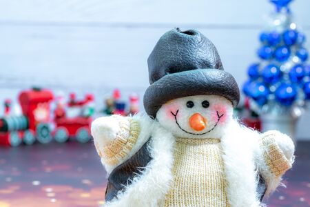 Close-up of snowman in foreground, Christmas Holiday Season background with decorations. Merry Christmas New Year collection, gifts and decorative ornaments. Empty copy space for text.の写真素材