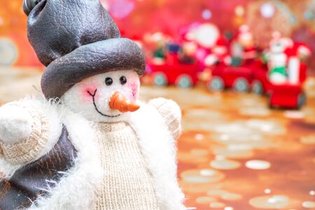 Close-up of snowman in foreground, Christmas Holiday Season background with decorations. Merry Christmas New Year collection, gifts and decorative ornaments. Empty copy space for text.の写真素材