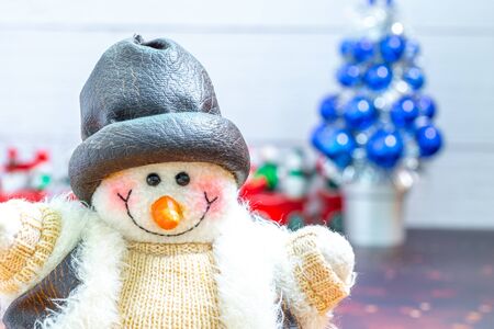 Close-up of snowman in foreground, Christmas Holiday Season background with decorations. Merry Christmas New Year collection, gifts and decorative ornaments. Empty copy space for text.の写真素材