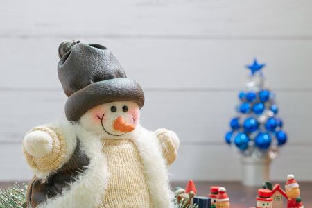 Close-up of snowman in foreground, Christmas Holiday Season background with decorations. Merry Christmas New Year collection, gifts and decorative ornaments. Empty copy space for text.の写真素材