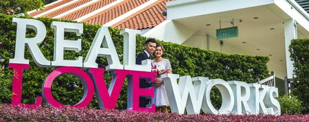 Asian loving couple pre-wedding outdoor photo shoot. Casual natural real people portraits. Loving romantic couple.の写真素材
