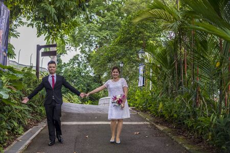 Asian loving couple pre-wedding outdoor photo shoot. Casual natural real people portraits. Loving romantic couple.の写真素材