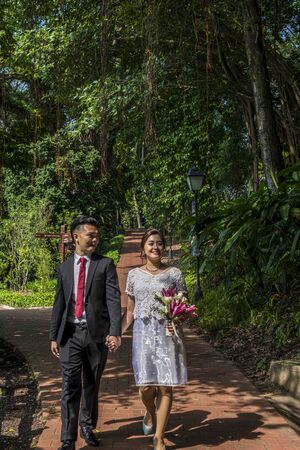 Asian loving couple pre-wedding outdoor photo shoot. Casual natural real people portraits. Loving romantic couple.の写真素材