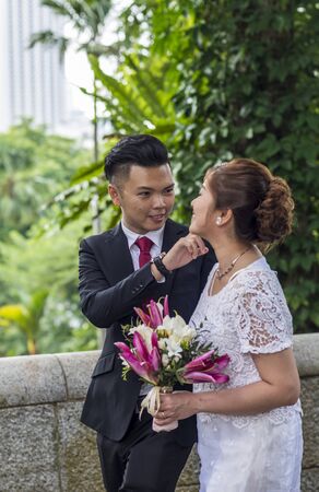 Asian loving couple pre-wedding outdoor photo shoot. Casual natural real people portraits. Loving romantic couple.の写真素材