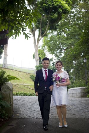 Asian loving couple pre-wedding outdoor photo shoot. Casual natural real people portraits. Loving romantic couple.の写真素材