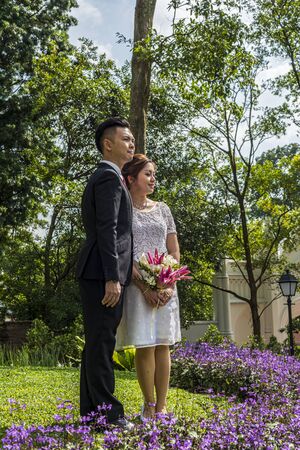 Asian loving couple pre-wedding outdoor photo shoot. Casual natural real people portraits. Loving romantic couple.の写真素材