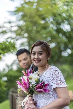 Asian loving couple pre-wedding outdoor photo shoot. Casual natural real people portraits. Loving romantic couple.の写真素材