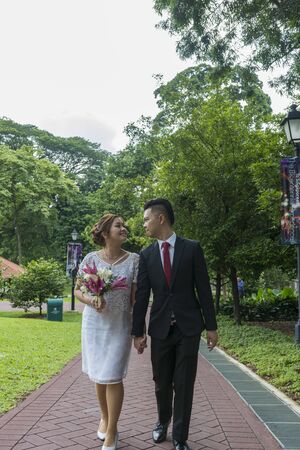 Asian loving couple pre-wedding outdoor photo shoot. Casual natural real people portraits. Loving romantic couple.の写真素材